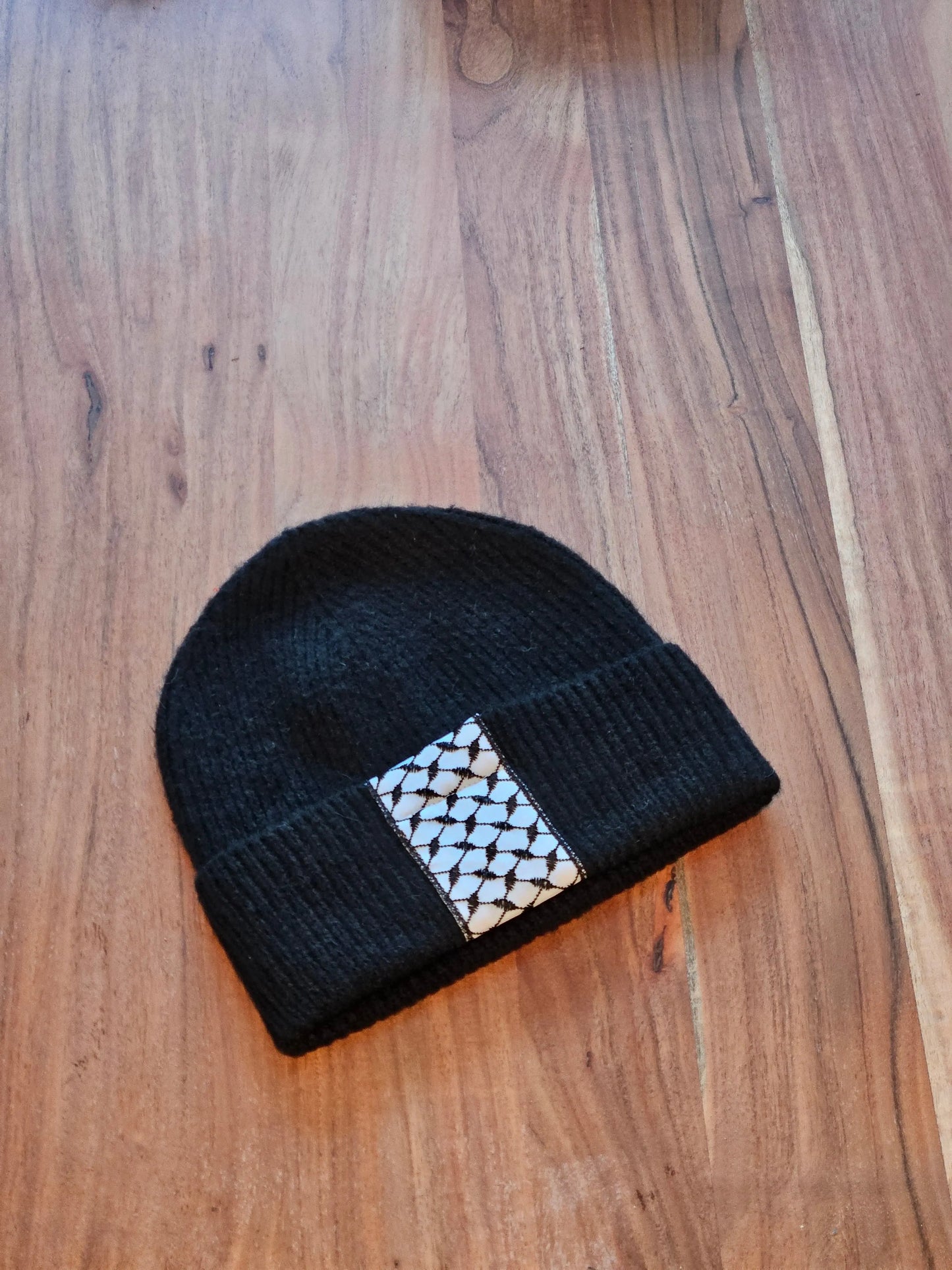 Black embroidered toque showing Tatreez pattern detail — Palestinian heritage winter hat by Mona Al Kurdi, Turath Fashion