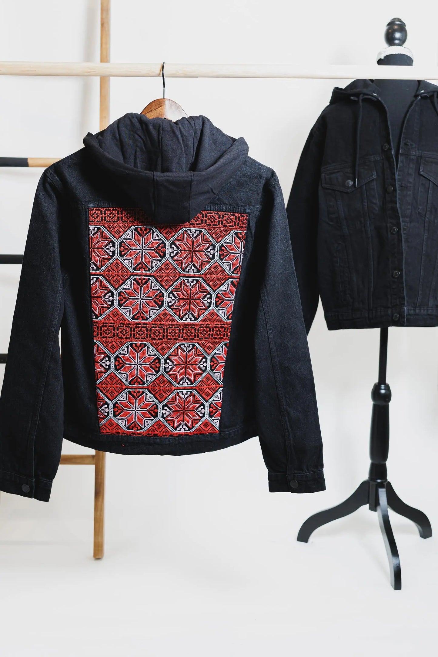 Black denim hooded jacket with Palestinian Tatreez embroidery on the back