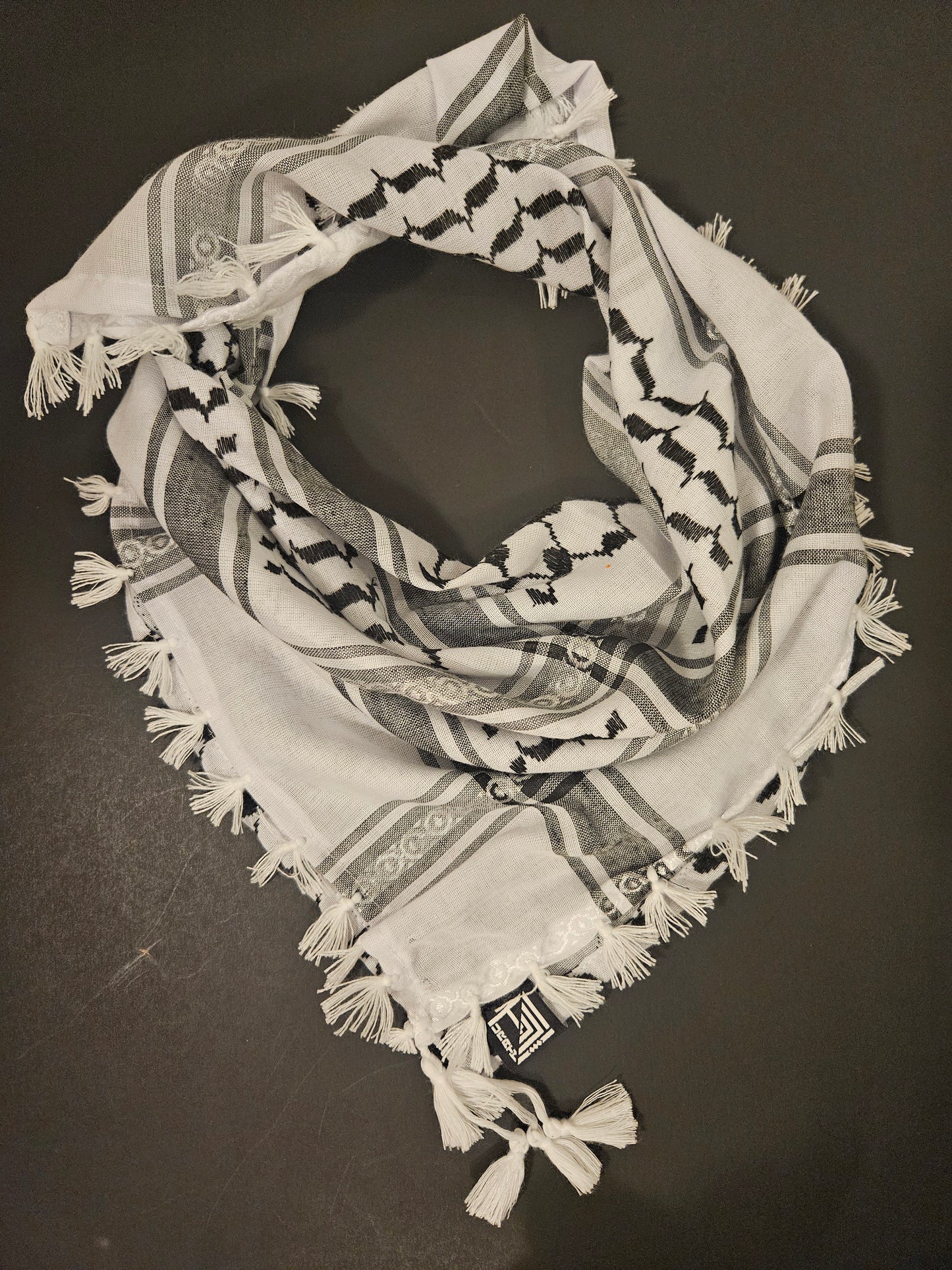 White keffiyeh bandana featuring embroidered Tatreez design, a timeless piece of Palestinian heritage and pride