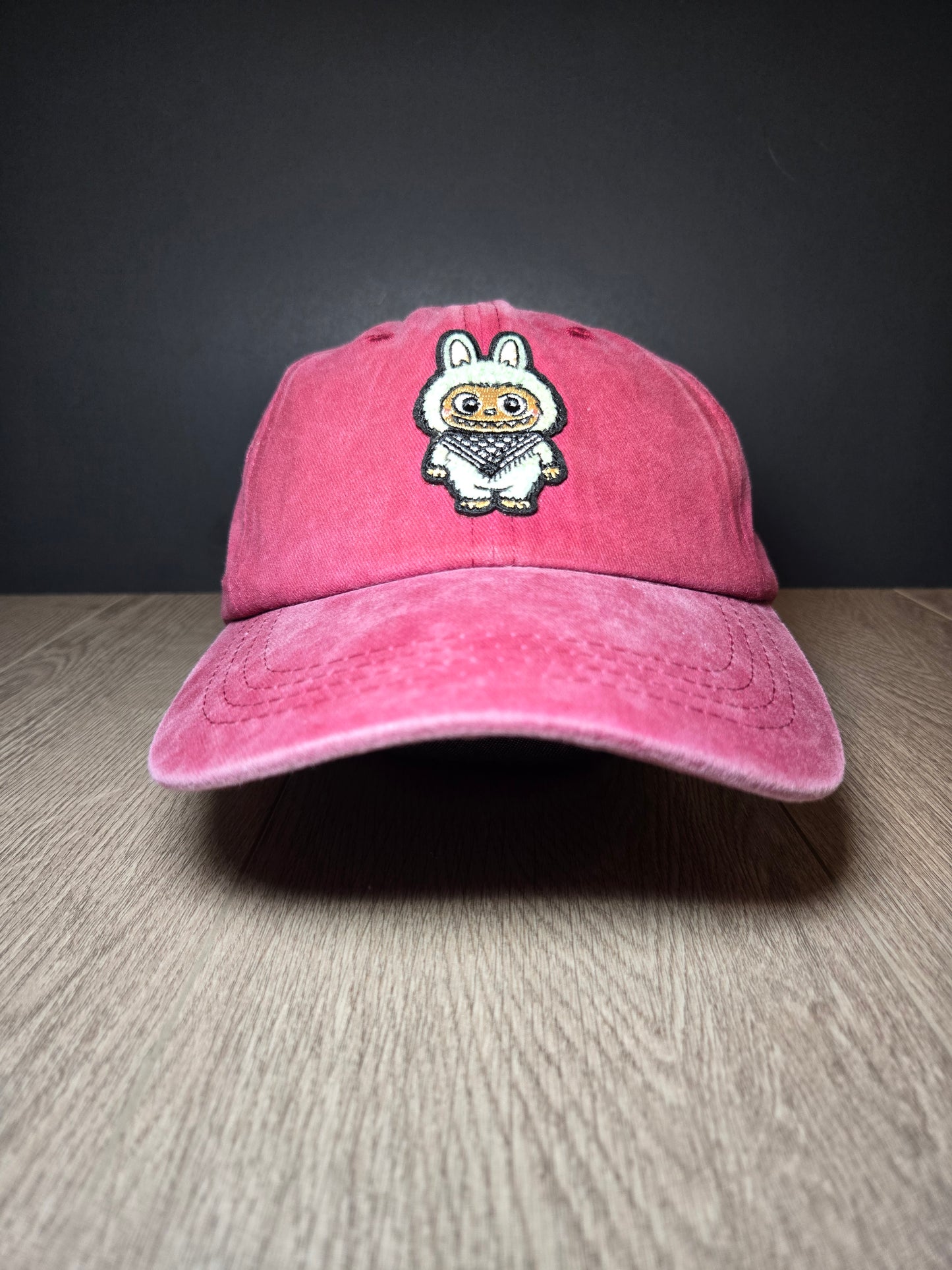 Light red cap featuring the Labubu cartoon character, a playful and vibrant embroidered design for a fun, unique style.