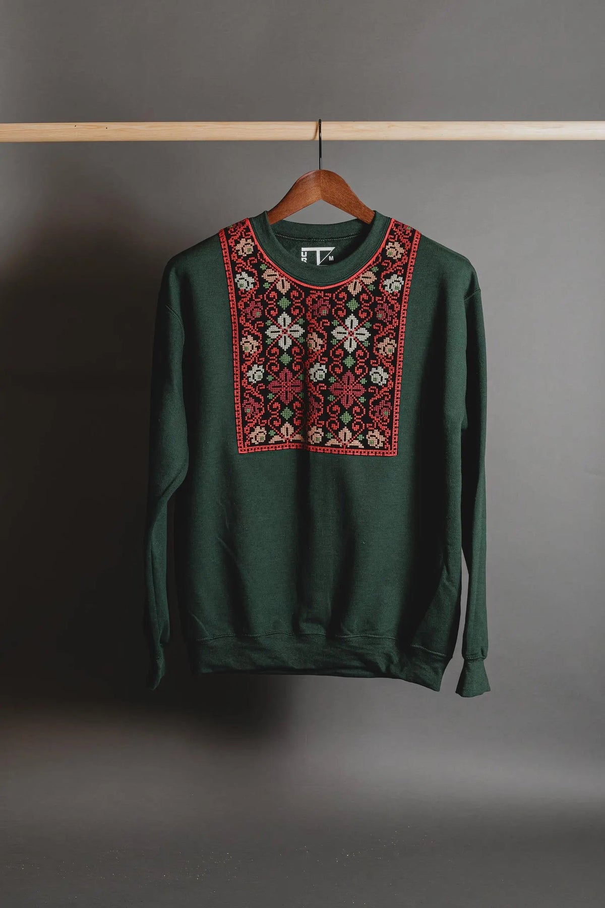 Forest green sweatshirt with multicolor flower Tatreez collar embroidery