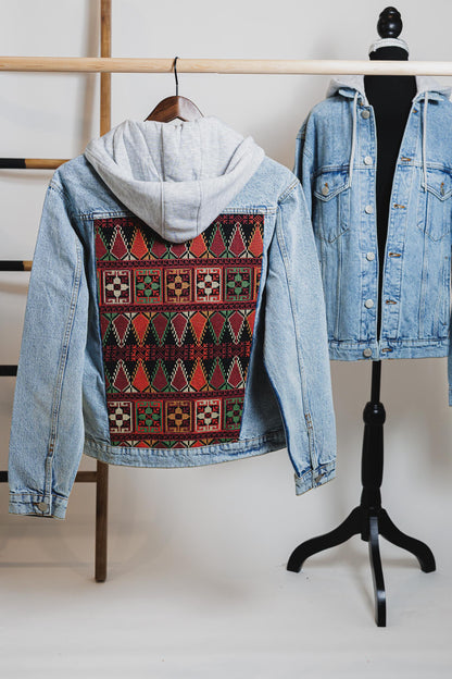 Detail view of the detachable cotton hood on the blue unisex embroidered denim jacket