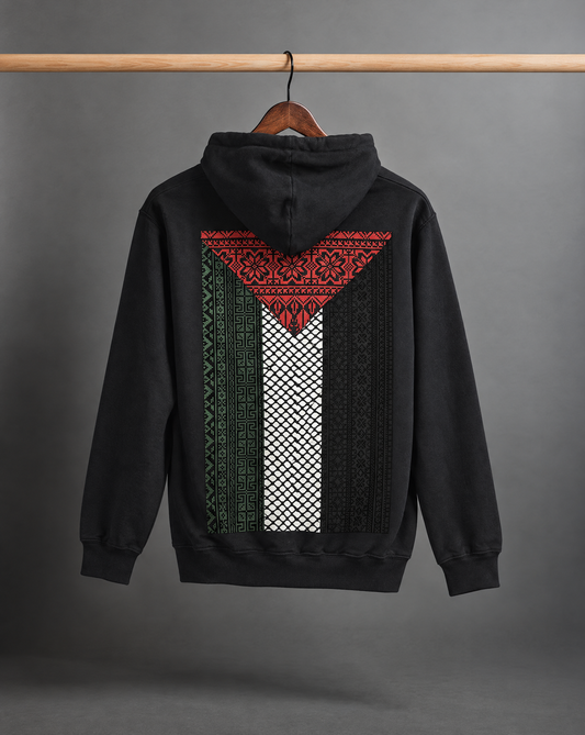 Black Palestine Flag Tatreez Patchwork Hoodie on a grey background