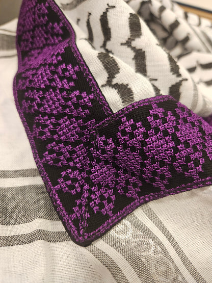 Close-up of a purple keffiyeh bandana featuring detailed Tatreez embroidery, showcasing Palestinian heritage and cultural pride.