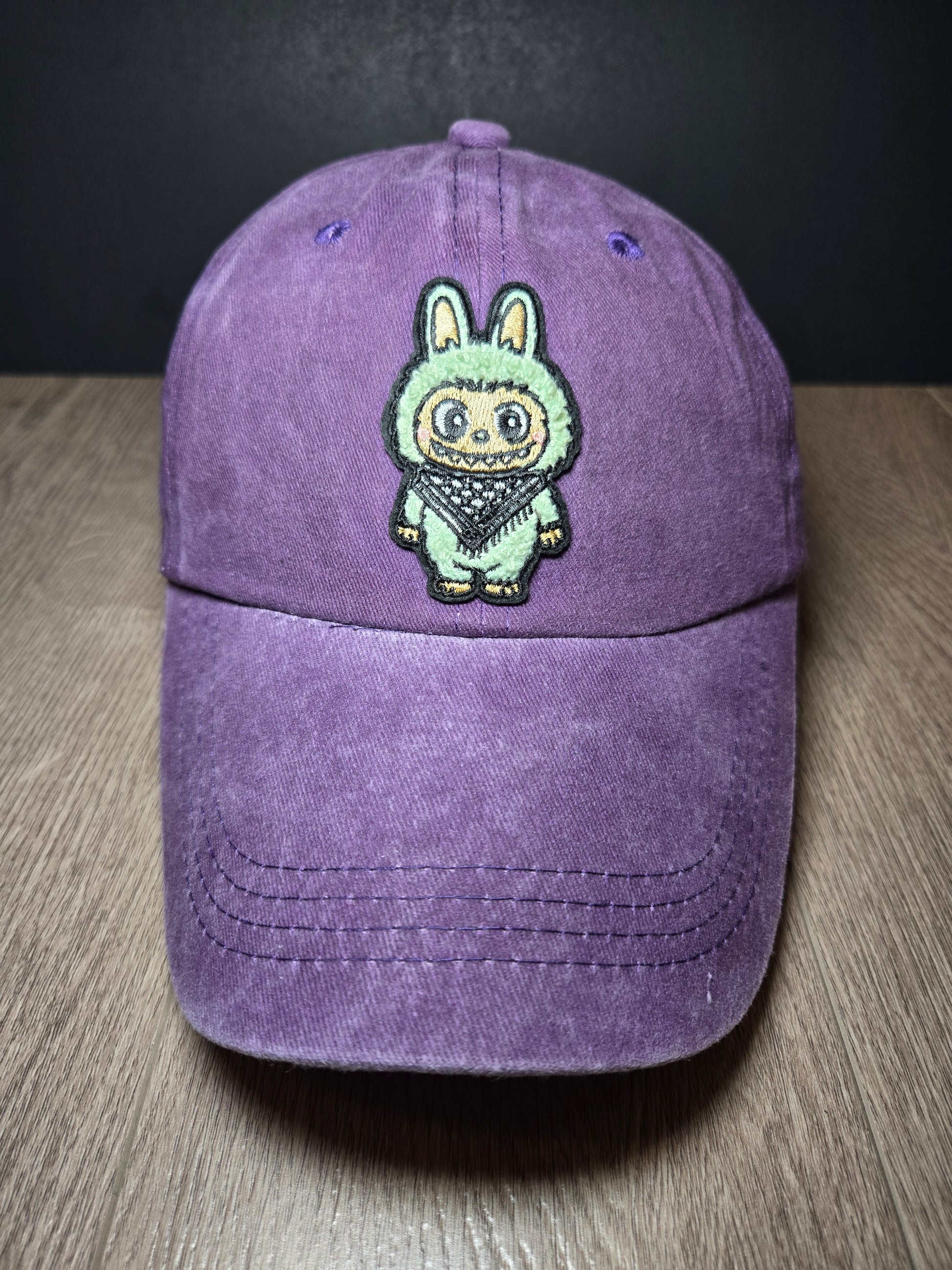 Dark purple cap featuring the Labubu cartoon character, a bold embroidered design for a playful and unique look.
