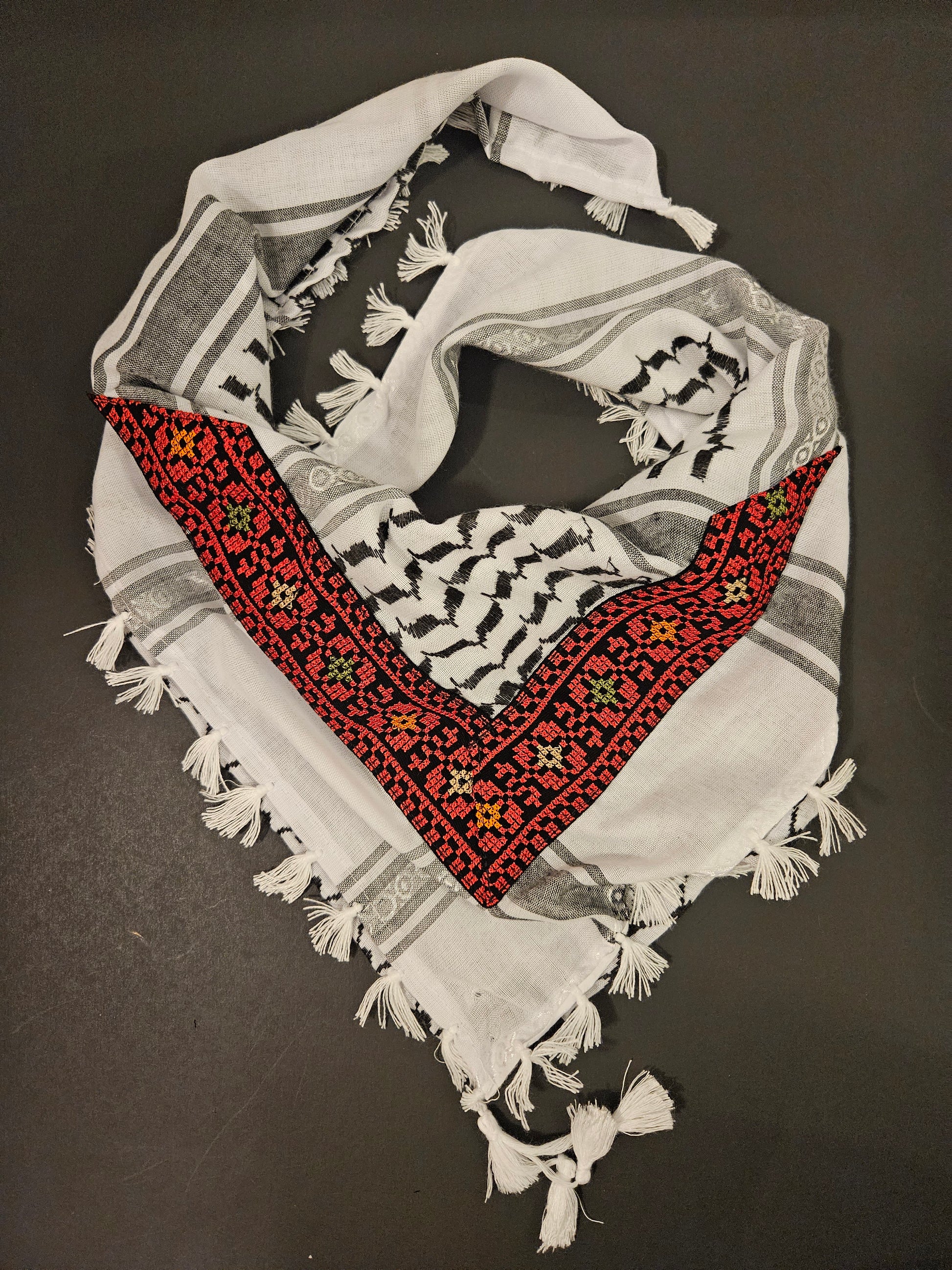 Decorative keffiyeh bandana with intricate Tatreez embroidery, combining cultural heritage with modern style for a unique accessory