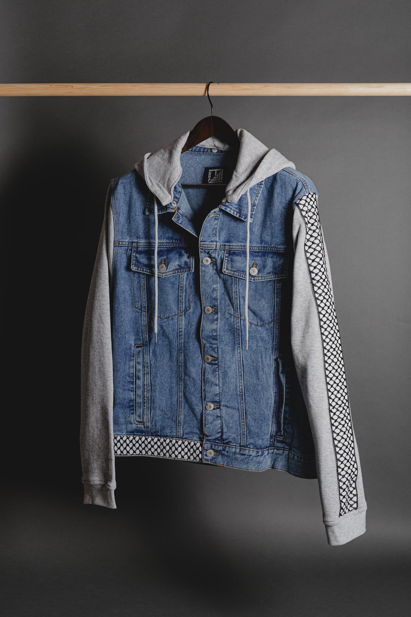 Front view of denim jacket with fleece sleeves and Palestinian Tatreez embroidery by Turath Fashion