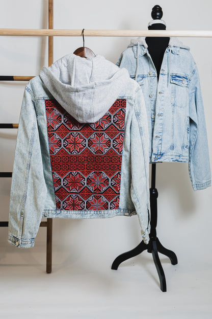 Unisex light blue denim jacket with gray hood and embroidered Palestinian Tatreez red pattern on back