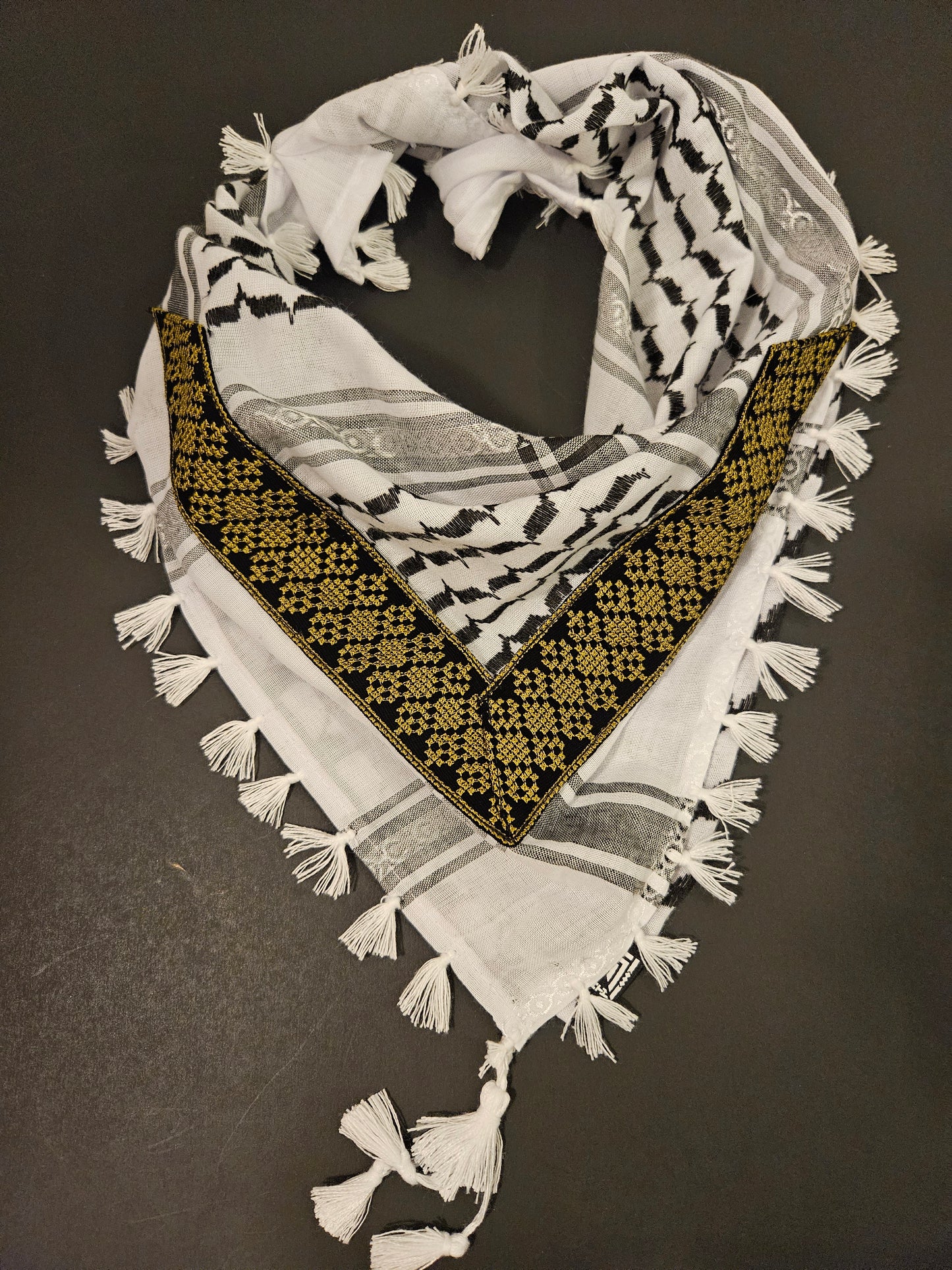 Elegant gold keffiyeh bandana with detailed Tatreez embroidery, a symbol of Palestinian culture and timeless craftsmanship