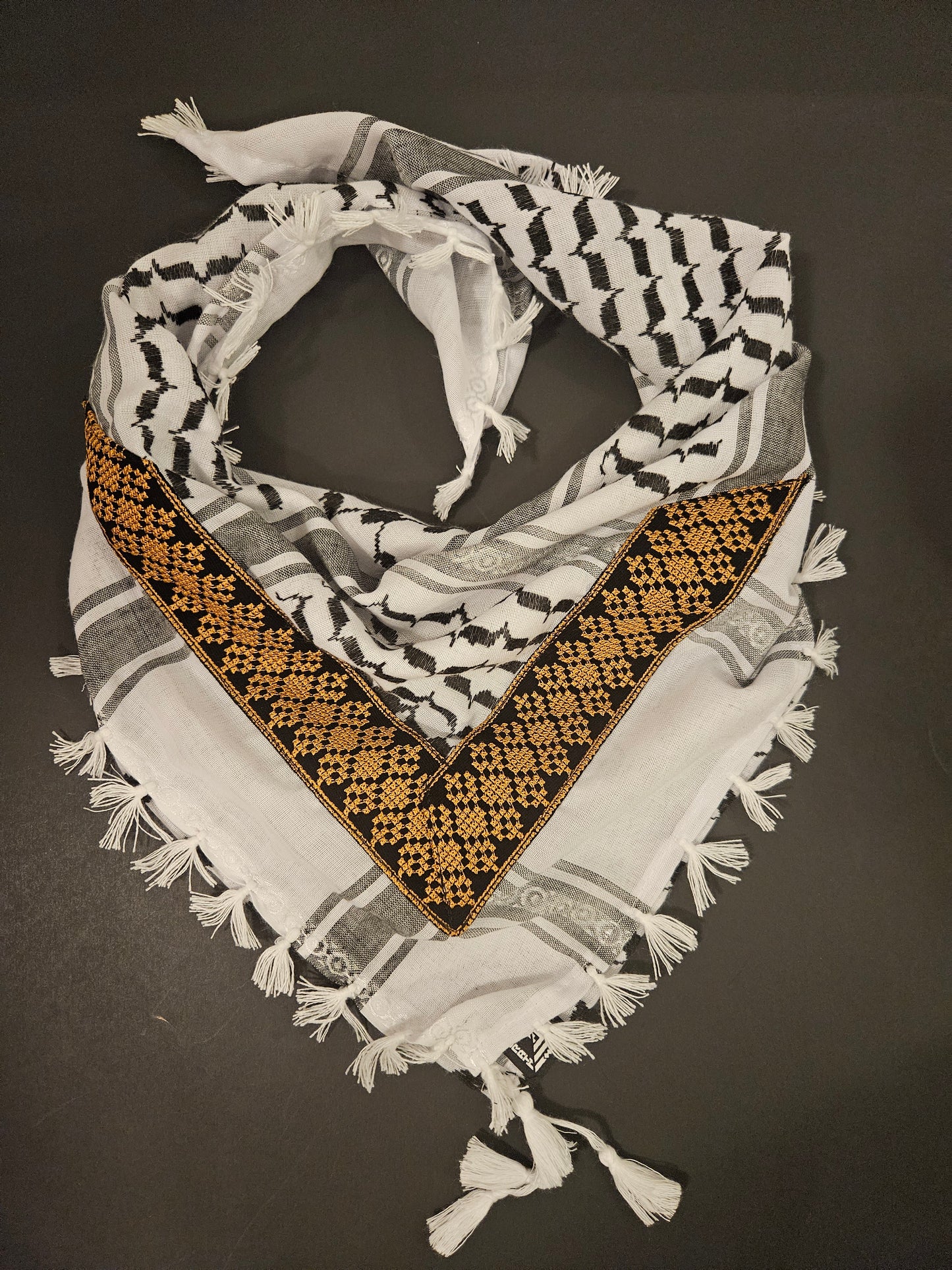 Gold keffiyeh bandana with intricate Tatreez embroidery, combining tradition with elegance and cultural symbolism