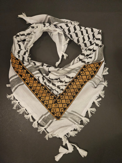 Gold keffiyeh bandana with intricate Tatreez embroidery, combining tradition with elegance and cultural symbolism