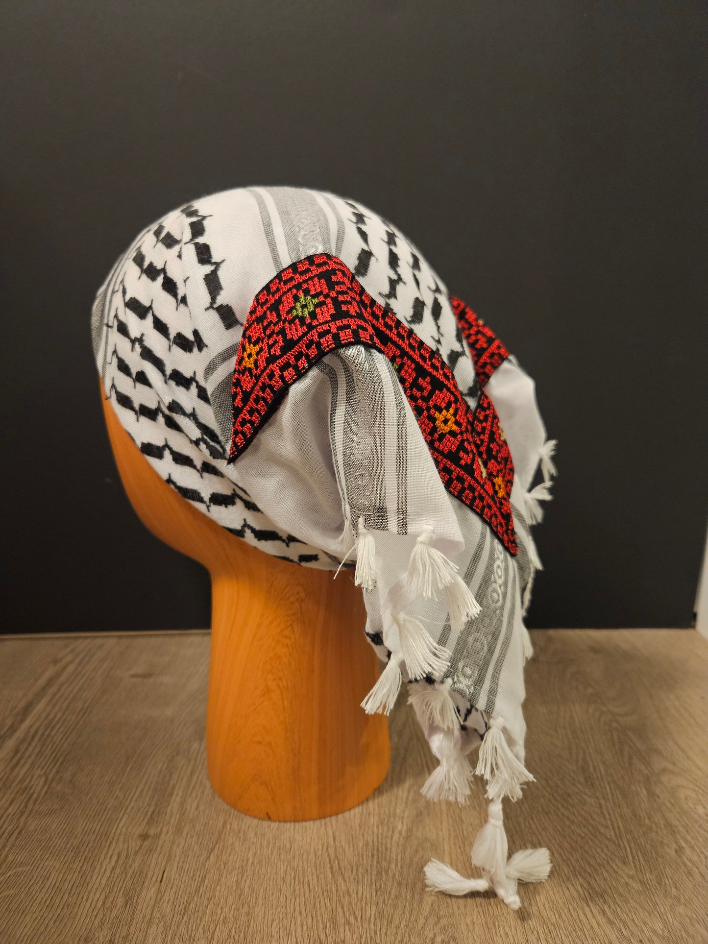 Red keffiyeh bandana with intricate Tatreez embroidery, symbolizing Palestinian heritage and cultural pride