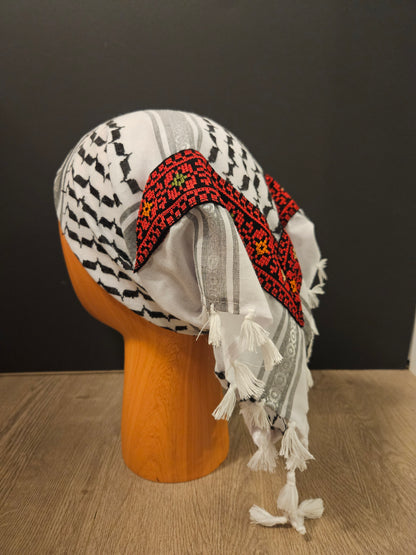 Red keffiyeh bandana with intricate Tatreez embroidery, symbolizing Palestinian heritage and cultural pride