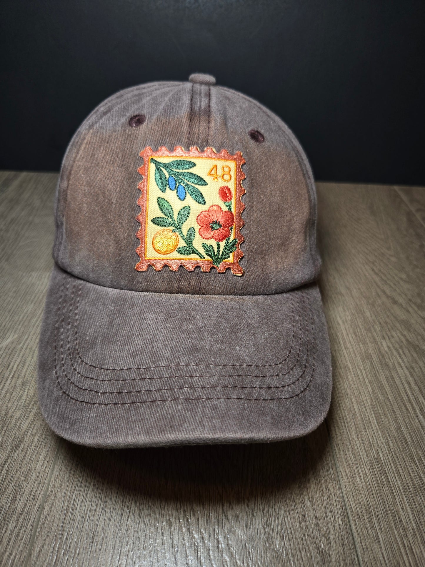 Brown unisex cap with embroidered Palestine postage stamp featuring floral design and the number 48
