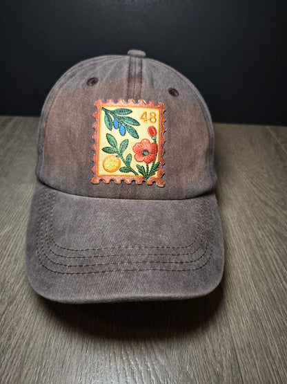 Brown unisex cap with embroidered Palestine postage stamp featuring floral design and the number 48
