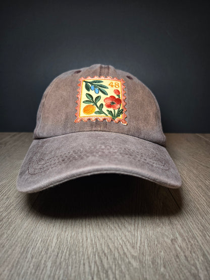 Green unisex cap with embroidered Palestine postage stamp featuring floral design and the number 48
