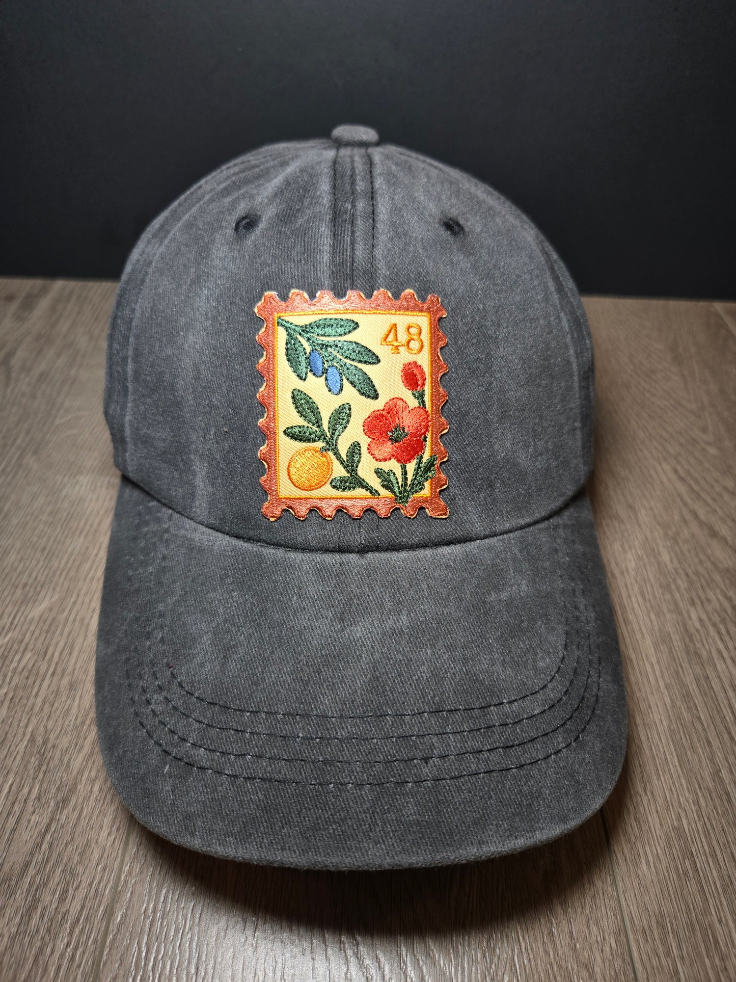 Vintage gray unisex cap with embroidered Palestine stamp and floral design, symbolizing pride.