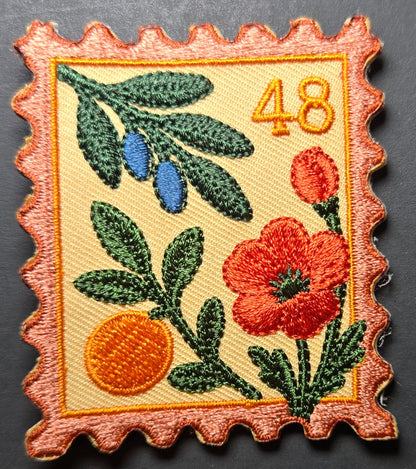 Close-up of embroidered Palestine postage stamp patch with floral design and the number 48