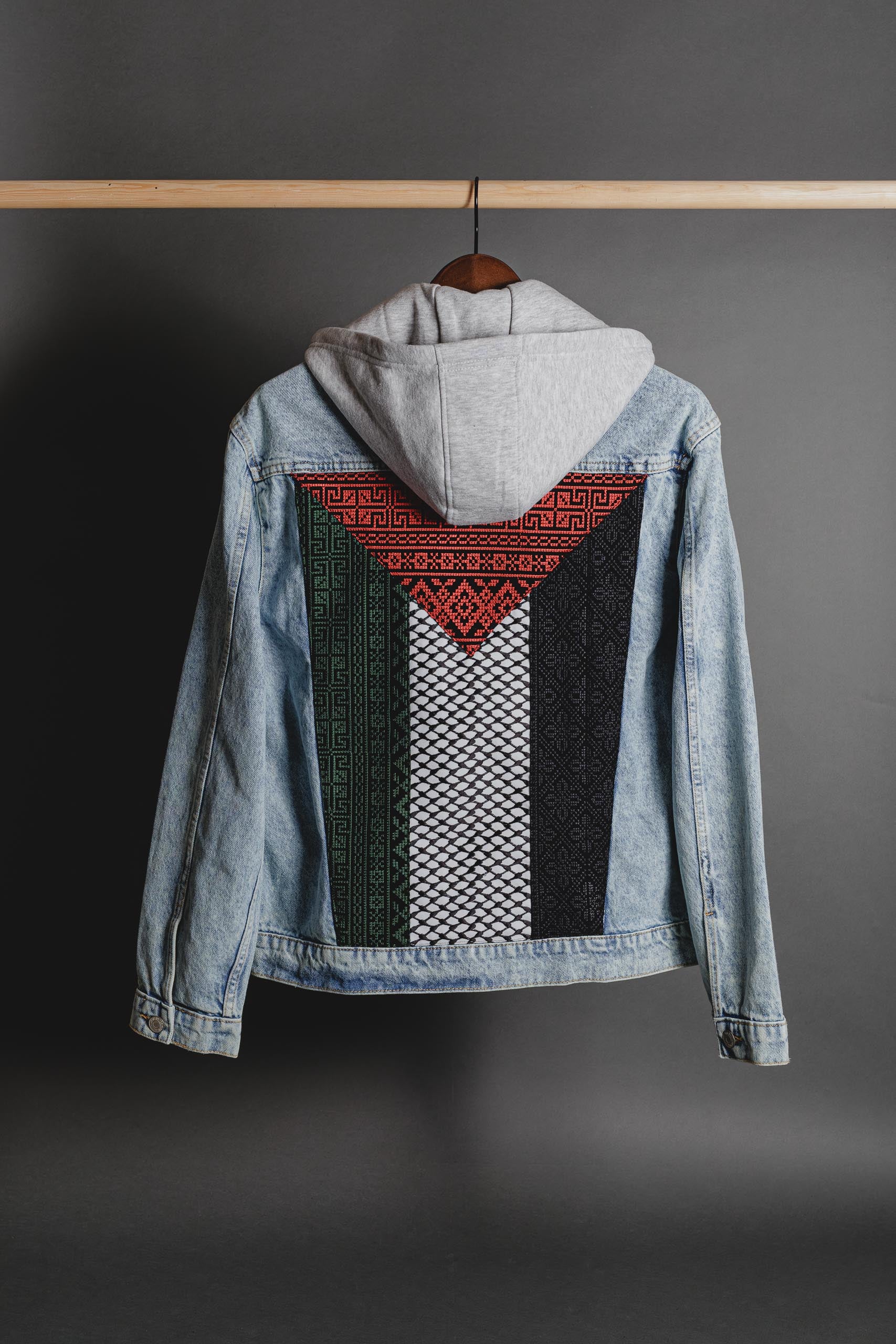Back view of denim jacket with bold keffiyeh and tatreez embroidery forming the Palestinian flag
