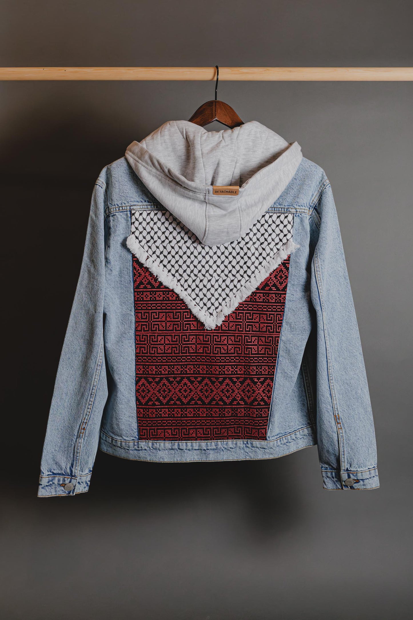 Detail of removable hood on Palestinian Keffiyeh denim jacket for versatile layering